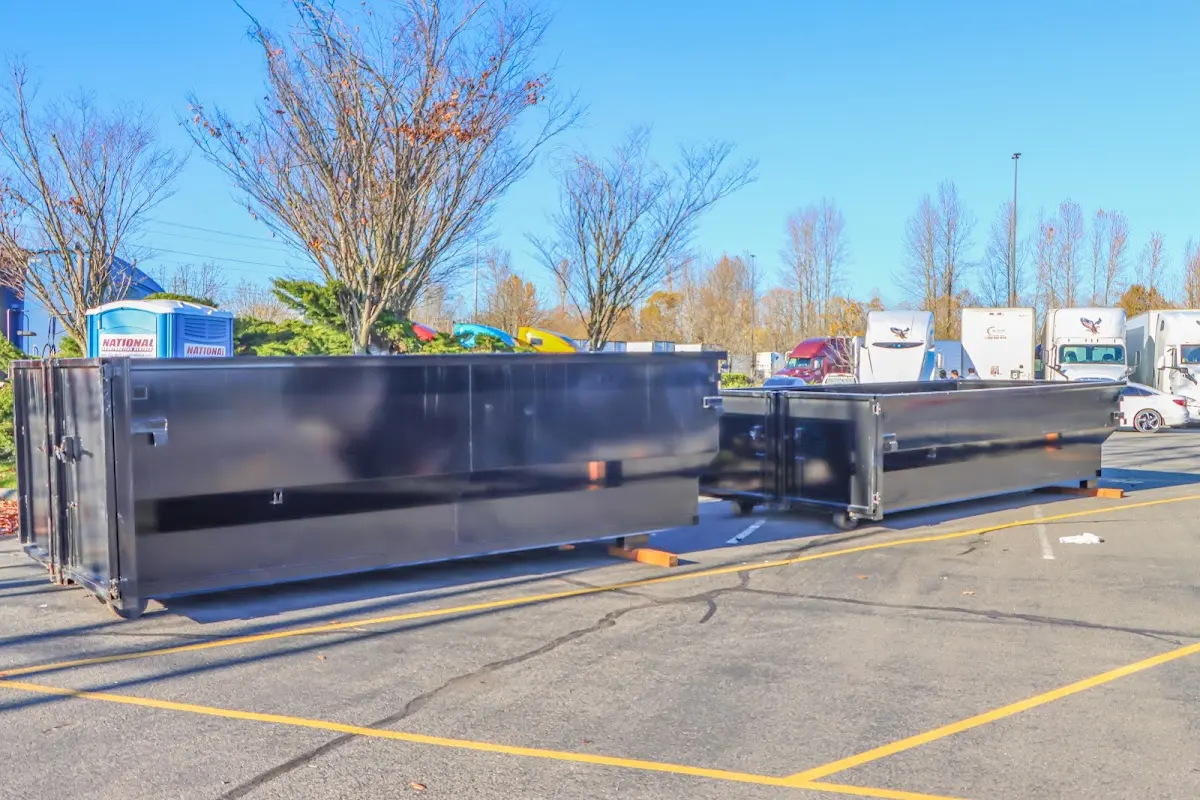 Professional dumpster rental service with roll-off container on residential driveway in Walker